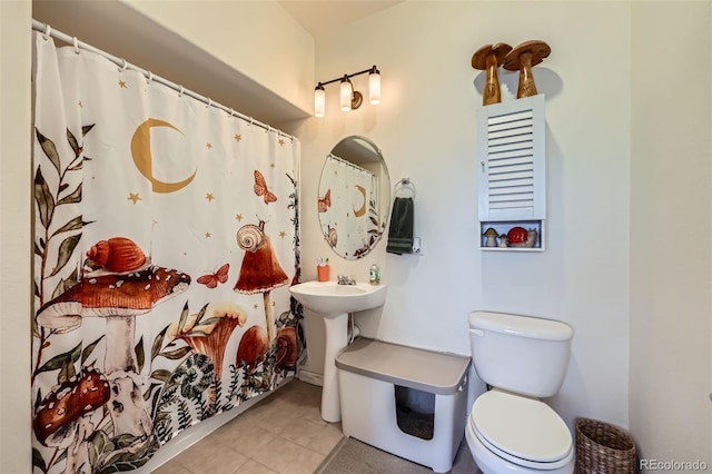 bathroom with toilet, tile patterned floors, and a shower with shower curtain