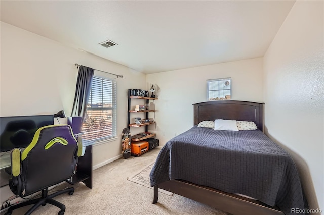 carpeted bedroom featuring visible vents and baseboards