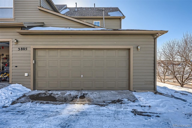 view of snow covered garage