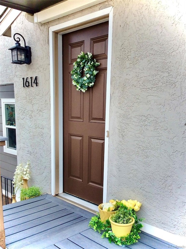 entrance to property with stucco siding