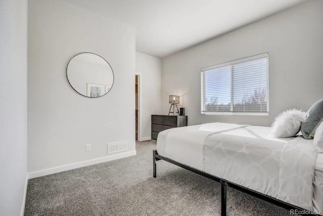carpeted bedroom featuring baseboards and visible vents