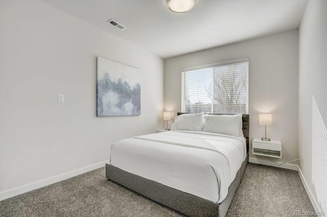 bedroom featuring baseboards, carpet flooring, and visible vents