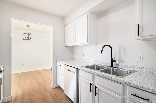 kitchen featuring dishwasher, white cabinetry, sink, and hanging light fixtures