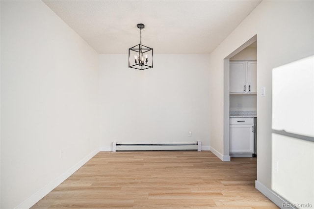 unfurnished dining area with baseboard heating, light hardwood / wood-style floors, and a chandelier