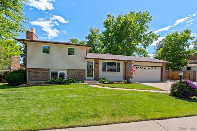 6143 S Ash Cir E, Centennial, CO 80121 - split level home featuring brick siding, a garage, driveway, and a chimney