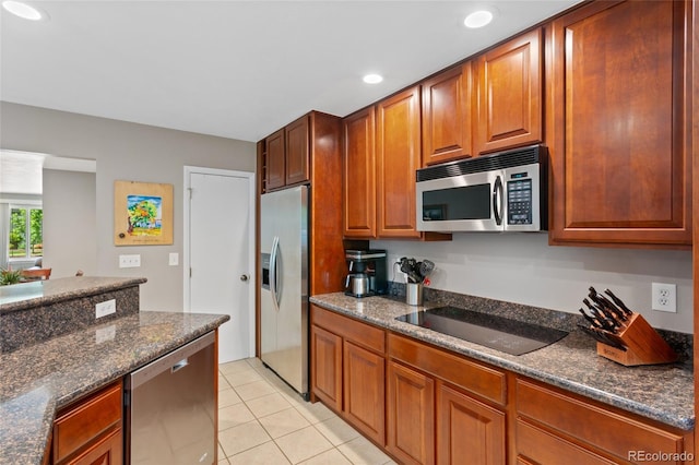6143 S Ash Cir E, Centennial, CO 80121 - kitchen featuring stainless steel appliances, light tile patterned floors, recessed lighting, dark stone countertops, and brown cabinets