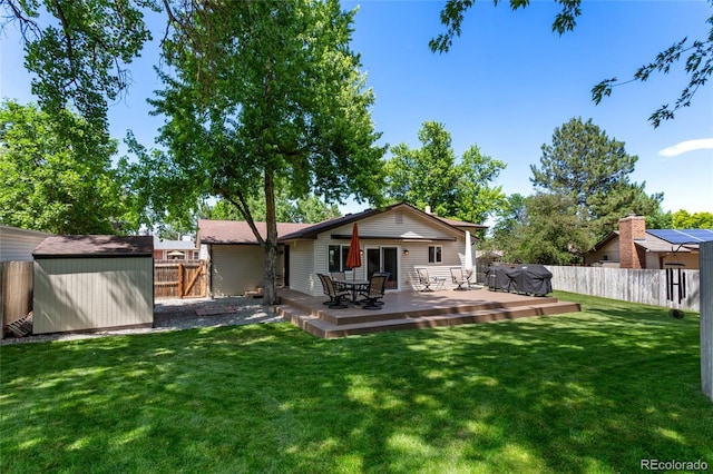 6143 S Ash Cir E, Centennial, CO 80121 - back of house featuring a shed, a fenced backyard, and a deck