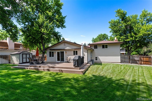 6143 S Ash Cir E, Centennial, CO 80121 - rear view of house with a shed, a wooden deck, and a chimney