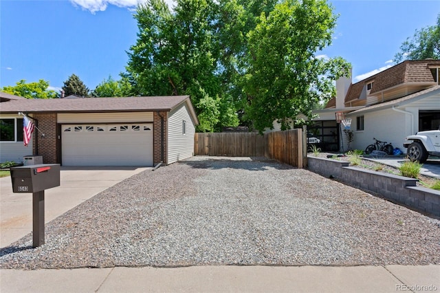 6143 S Ash Cir E, Centennial, CO 80121 - view of front facade with concrete driveway, brick siding, and a garage