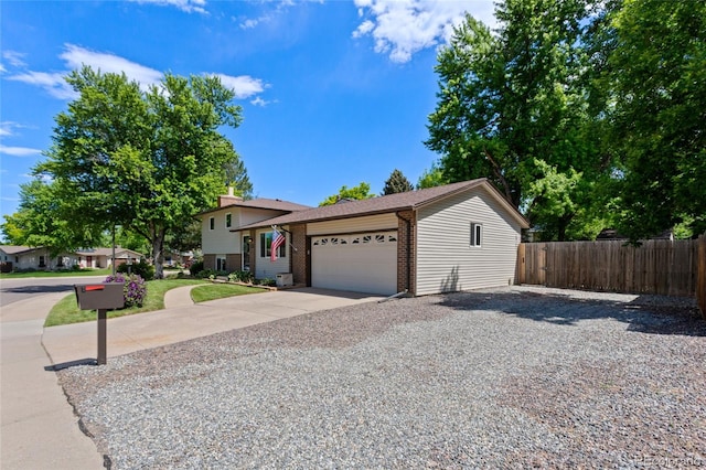 6143 S Ash Cir E, Centennial, CO 80121 - split level home featuring concrete driveway, an attached garage, and brick siding