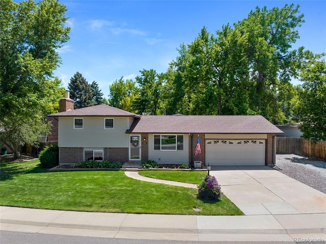 6143 S Ash Cir E, Centennial, CO 80121 - split level home with brick siding, an attached garage, a chimney, and concrete driveway