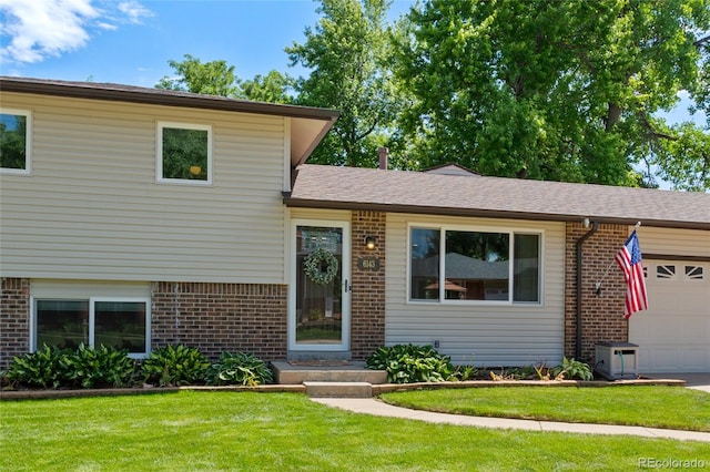 6143 S Ash Cir E, Centennial, CO 80121 - tri-level home with brick siding, a garage, a front lawn, and roof with shingles
