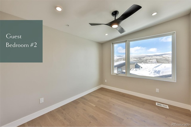 unfurnished room with ceiling fan, light hardwood / wood-style flooring, and lofted ceiling