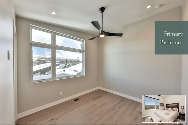 empty room with light wood-type flooring and ceiling fan