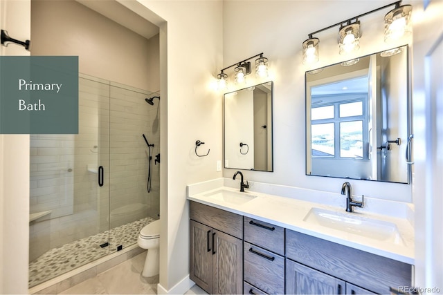 bathroom with tile patterned floors, an enclosed shower, vanity, and toilet