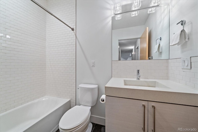 bathroom featuring tasteful backsplash, tub / shower combination, vanity, and toilet