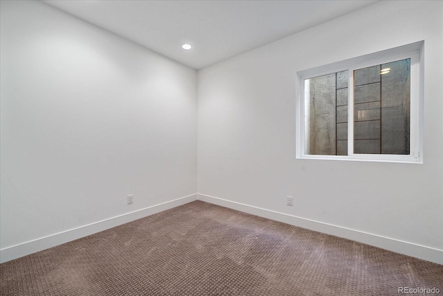 carpeted empty room featuring recessed lighting and baseboards