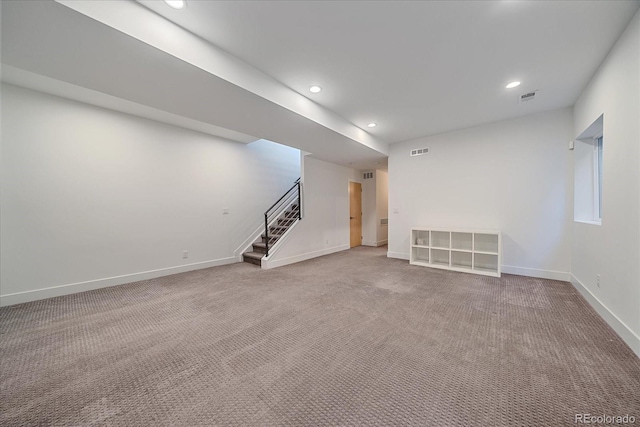 carpeted spare room with stairway, recessed lighting, visible vents, and baseboards