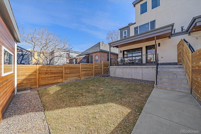 view of yard featuring fence and a porch