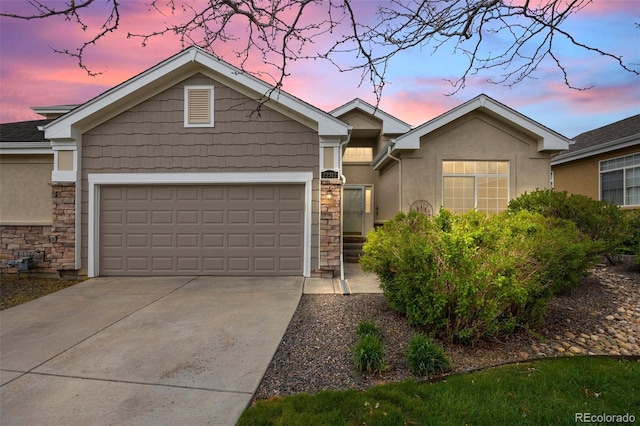 22312 E Plymouth Cir, Aurora, CO 80016 - ranch-style home with stone siding, a garage, concrete driveway, and stucco siding