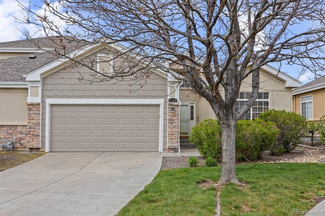 22312 E Plymouth Cir, Aurora, CO 80016 - single story home featuring stone siding, driveway, stucco siding, and an attached garage