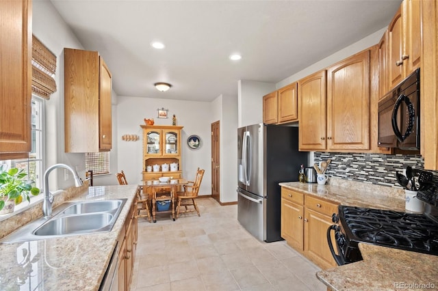 22312 E Plymouth Cir, Aurora, CO 80016 - kitchen with black appliances, a sink, backsplash, recessed lighting, and light stone counters