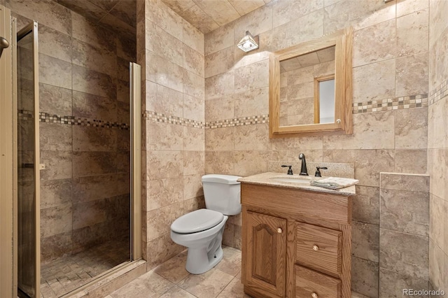 22312 E Plymouth Cir, Aurora, CO 80016 - full bath with a stall shower, vanity, toilet, and tile walls