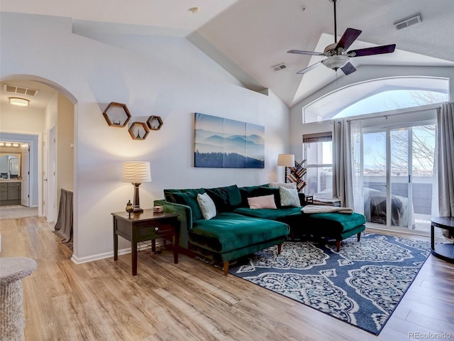 living room featuring ceiling fan, high vaulted ceiling, and light hardwood / wood-style floors