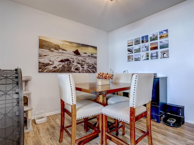 dining space with hardwood / wood-style floors