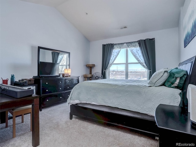 bedroom featuring vaulted ceiling and carpet floors