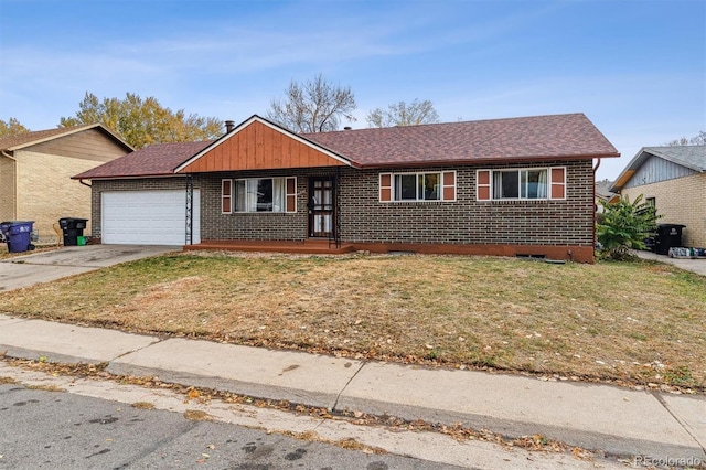 ranch-style house featuring a garage, a front yard, brick siding, and driveway