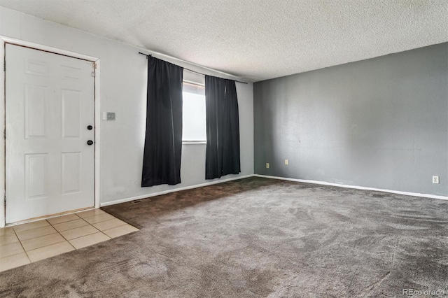 entrance foyer featuring carpet and a textured ceiling