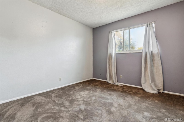 carpeted spare room featuring a textured ceiling