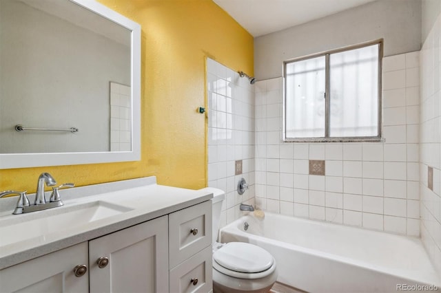 full bathroom featuring vanity, toilet, and tiled shower / bath