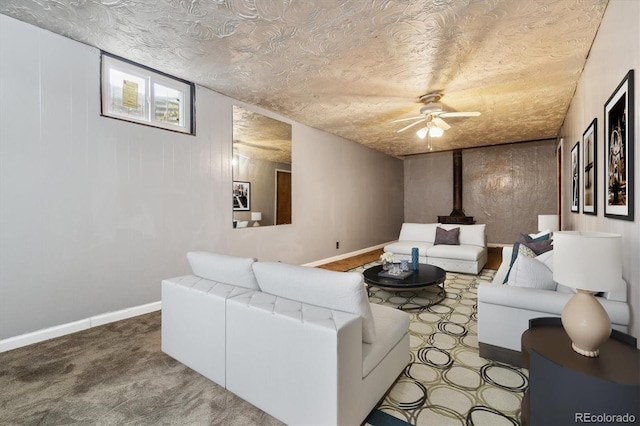 living room featuring a textured ceiling, carpet floors, and ceiling fan