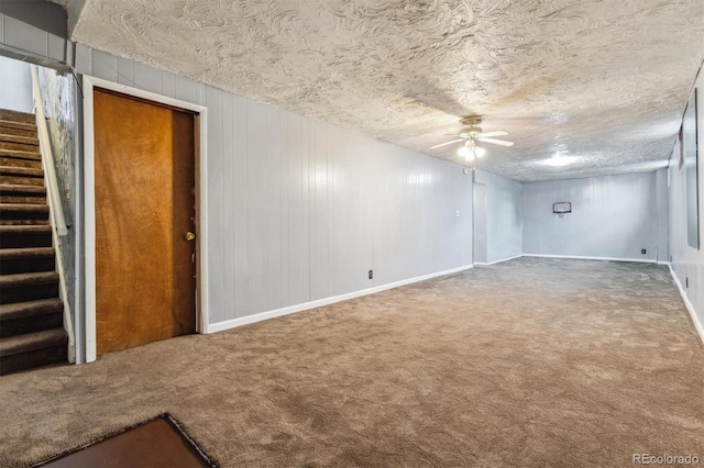 empty room with carpet, ceiling fan, and a textured ceiling