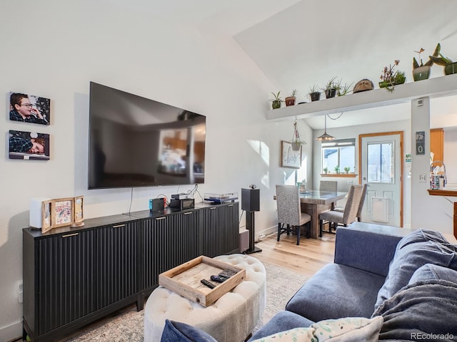 living room with lofted ceiling and light hardwood / wood-style floors