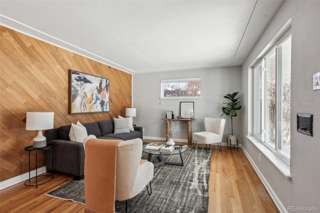 living room featuring hardwood / wood-style flooring, a wealth of natural light, and wood walls