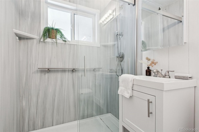 bathroom with vanity and a shower with shower door