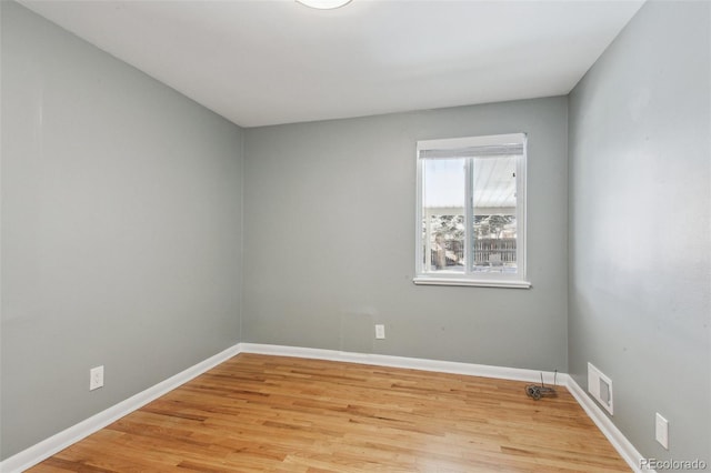 unfurnished room with light wood-type flooring