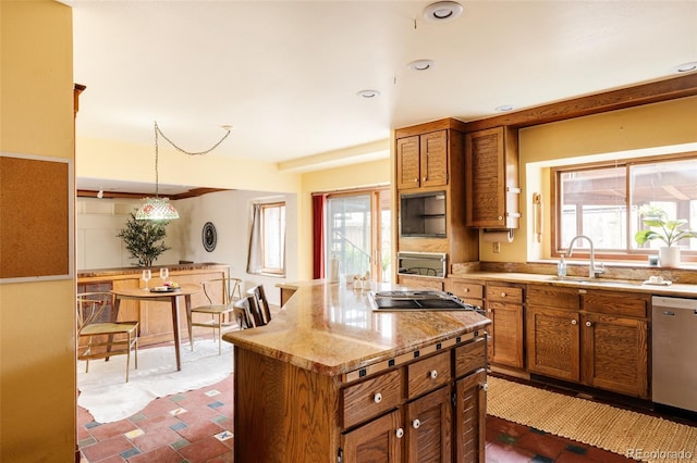 kitchen featuring brown cabinets, a sink, a kitchen island, cooktop, and dishwasher