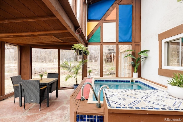 sunroom featuring beam ceiling