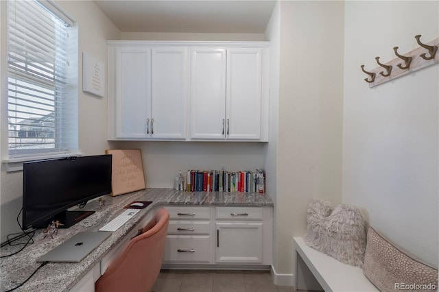 home office with light tile patterned flooring and built in study area