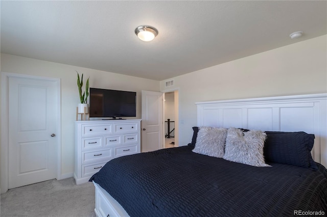 bedroom featuring light colored carpet and visible vents