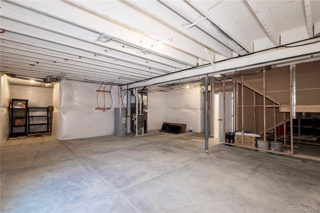 unfinished basement featuring water heater and heating unit