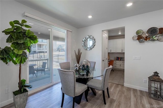 8240 S White Crow St, Aurora, CO 80016 - dining space featuring light wood-style floors, recessed lighting, and baseboards