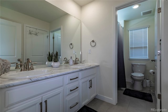 8240 S White Crow St, Aurora, CO 80016 - bathroom featuring toilet, tile patterned flooring, double vanity, and baseboards