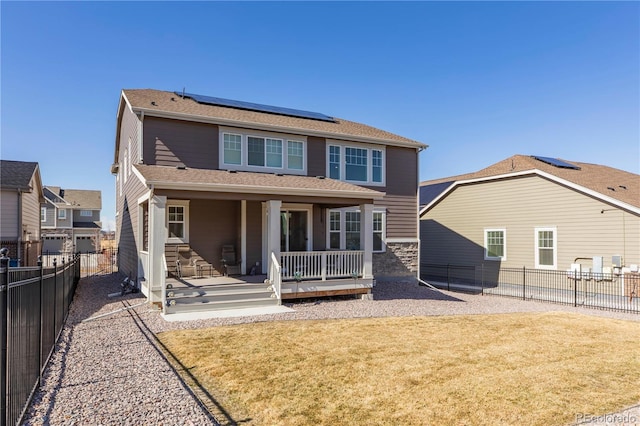 8240 S White Crow St, Aurora, CO 80016 - rear view of house with roof mounted solar panels and covered porch