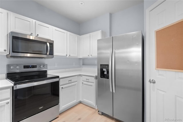 12711 Colorado Blvd Unit 1116, Thornton, CO 80241 - kitchen with stainless steel appliances, white cabinetry, light countertops, and light wood-style floors