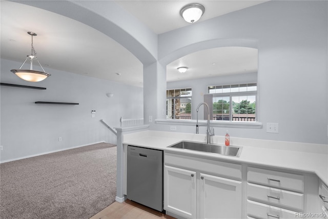 12711 Colorado Blvd Unit 1116, Thornton, CO 80241 - kitchen featuring stainless steel dishwasher, a sink, arched walkways, white cabinetry, and light countertops